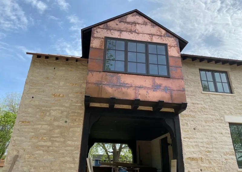 Copper metal panel facade on a stone building for Roof Repair in McAllen